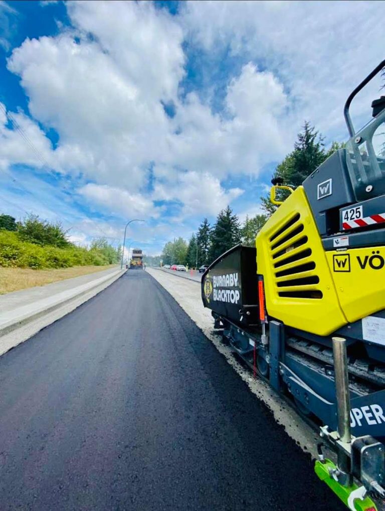 burnaby blacktop equipment besides a freshly paved road