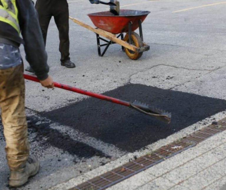 Paving contractors working on a pot hole in Vancouver
