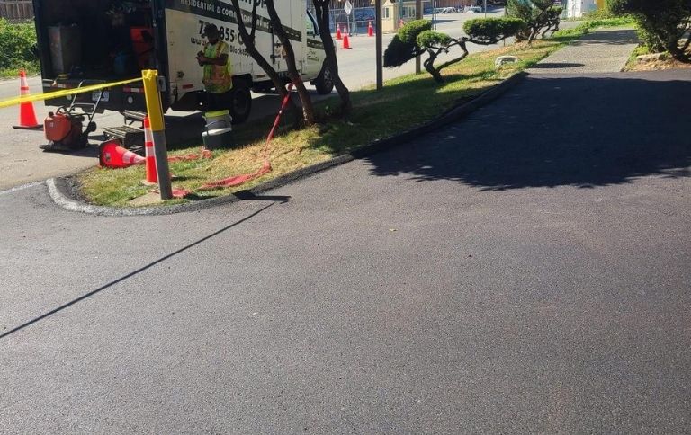 paved road in port moody with burnaby blacktop equipment and team in the back