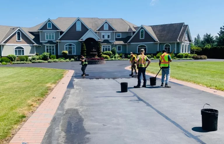 seal coating professionals finishing a driveway in Langley