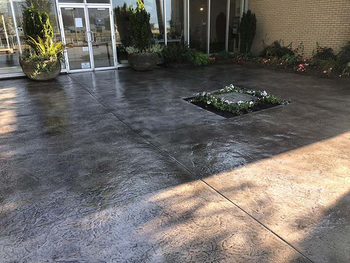 beautiful stamped concrete with flora in the middle