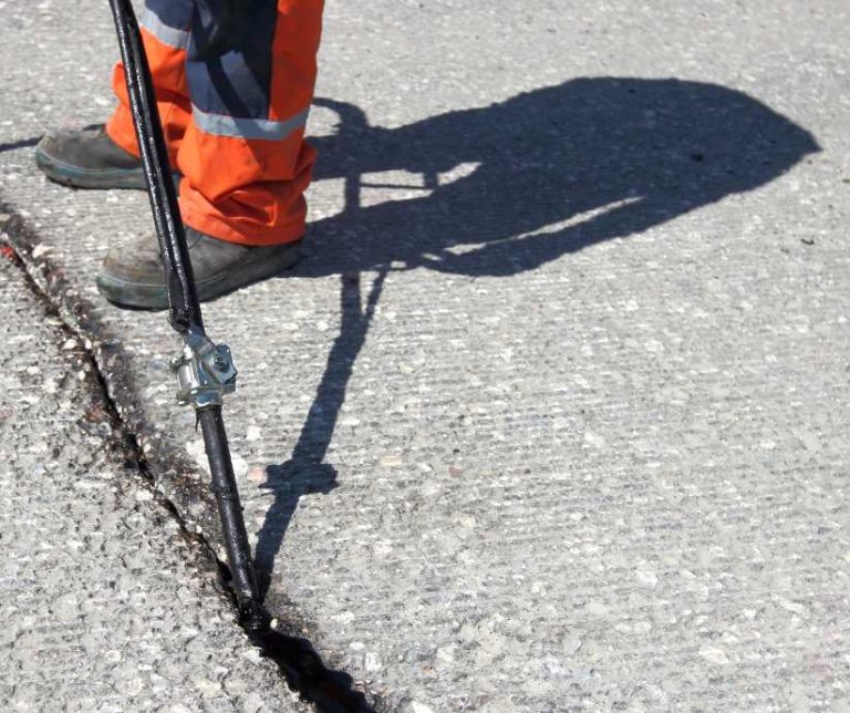 crack sealing services - sealing crack in pavement