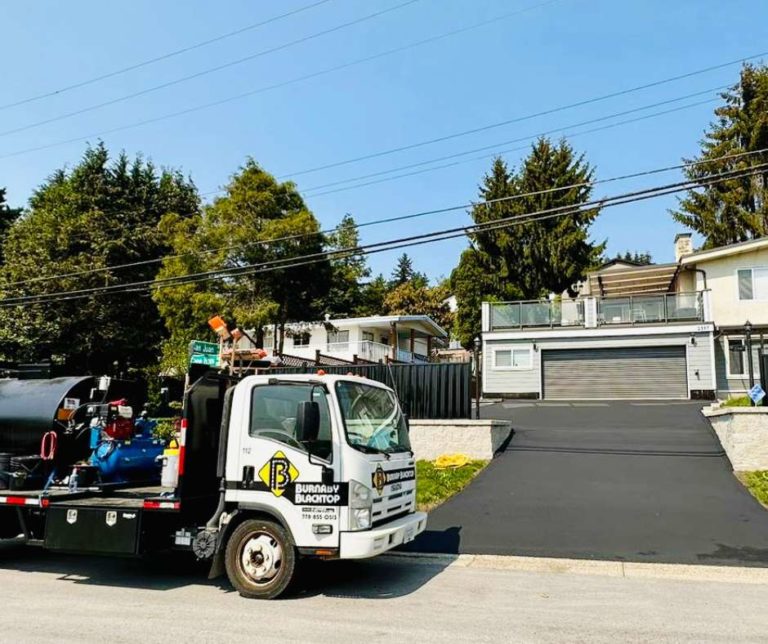 burnaby blacktop's seal coating equipment in front of a recently seal coated driveway