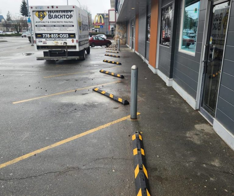 rubber curbs in the front parking lot of a small business in burnaby
